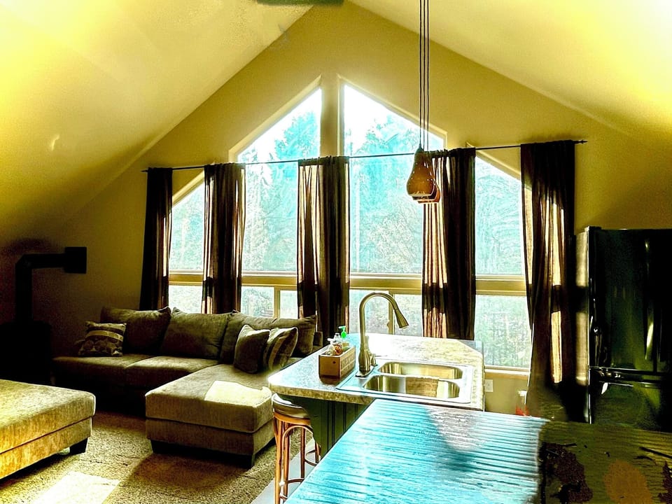 Relax in the open living room as sunshine wanders in with the large windows. 