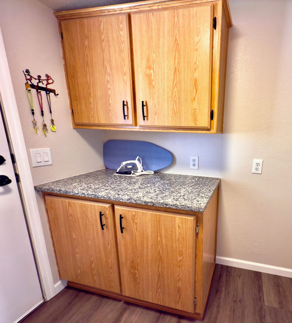 More storage. Full and half sized ironing boards. Iron and first aid kit