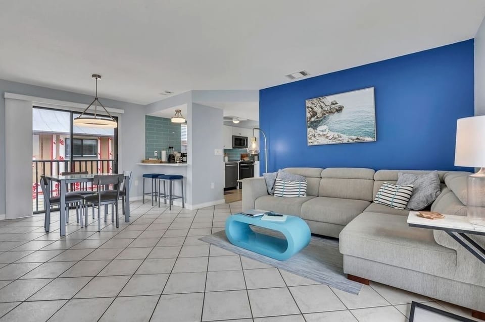 Step into the sun drenched living room with dual sliders & dazzling gulf views!
