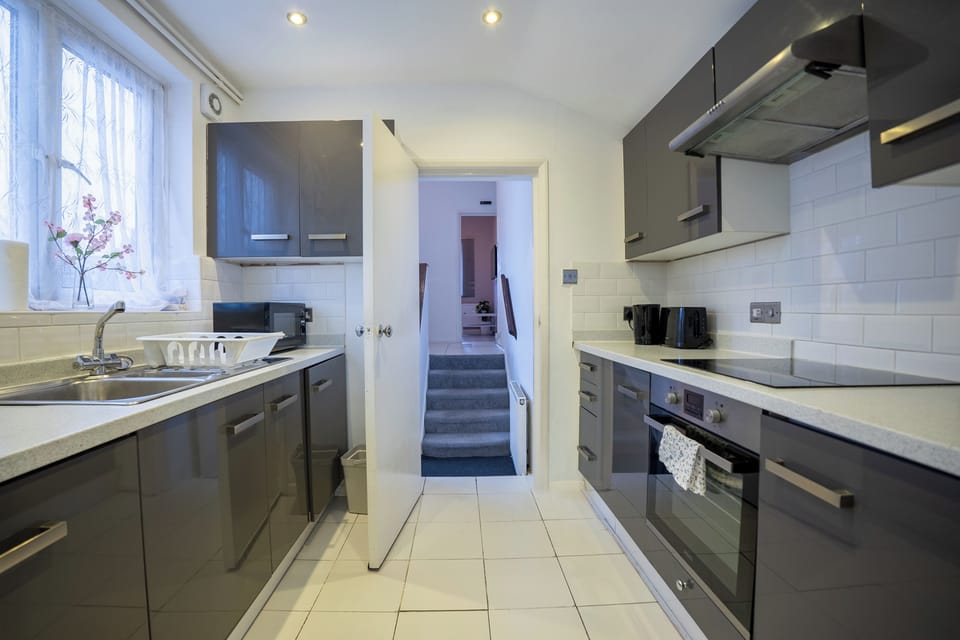 There are utensils, plates/bowls, cups, wine glasses, mugs, washing machine/dryer, dishwasher and tablets, fridge and freezer, oven and induction hob, bin bags, kitchen roll, washing up liquid and sponge, tea towel, coffee/tea, sugar, salt and pepper.