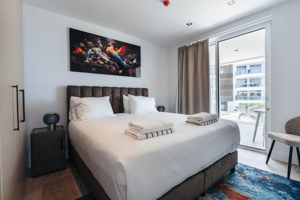 Welcome to your happy place! This vibrant bedroom is ready for cozy nights and sunshine-filled mornings!