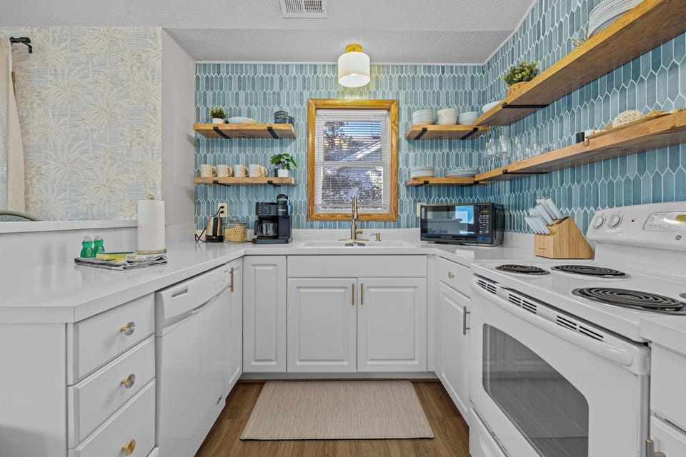 Features a large island, ample cabinetry, and high-end appliances, making it perfect for cooking, entertaining, and gathering with loved ones. 