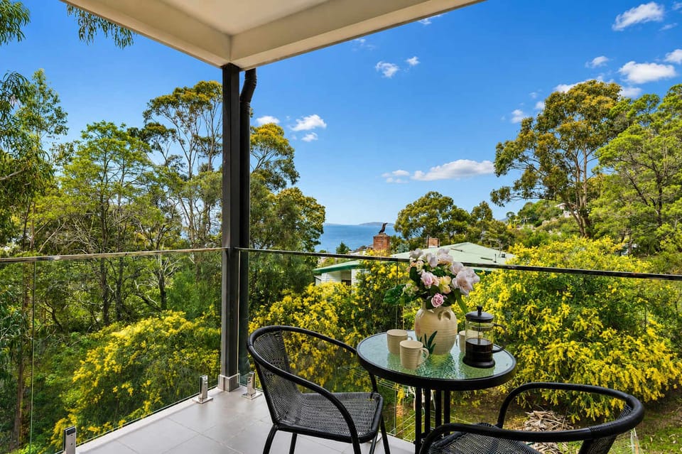 Start your morning with coffee on your private deck, surrounded by peaceful treetops and views towards the Derwent River.