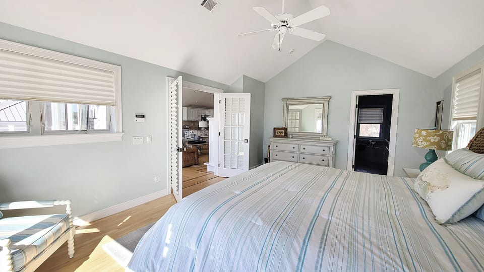 Second floor primary bedroom with king bed, ensuite bathroom and incredible views