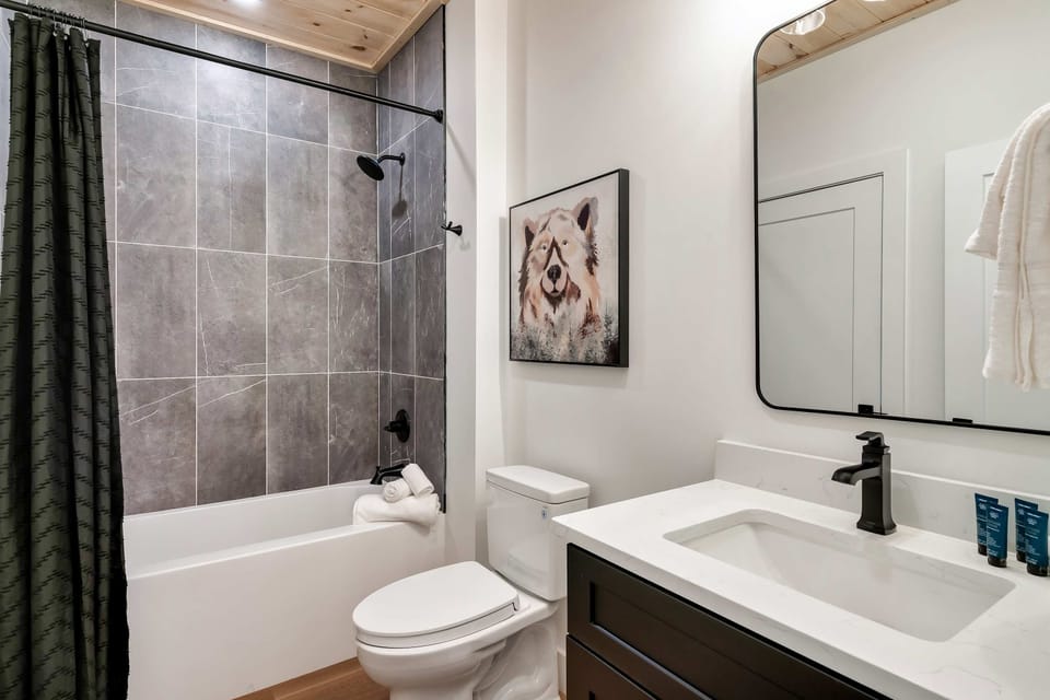 Spa-like retreat featuring sleek tiles, modern decor, and a wolf-themed accent.