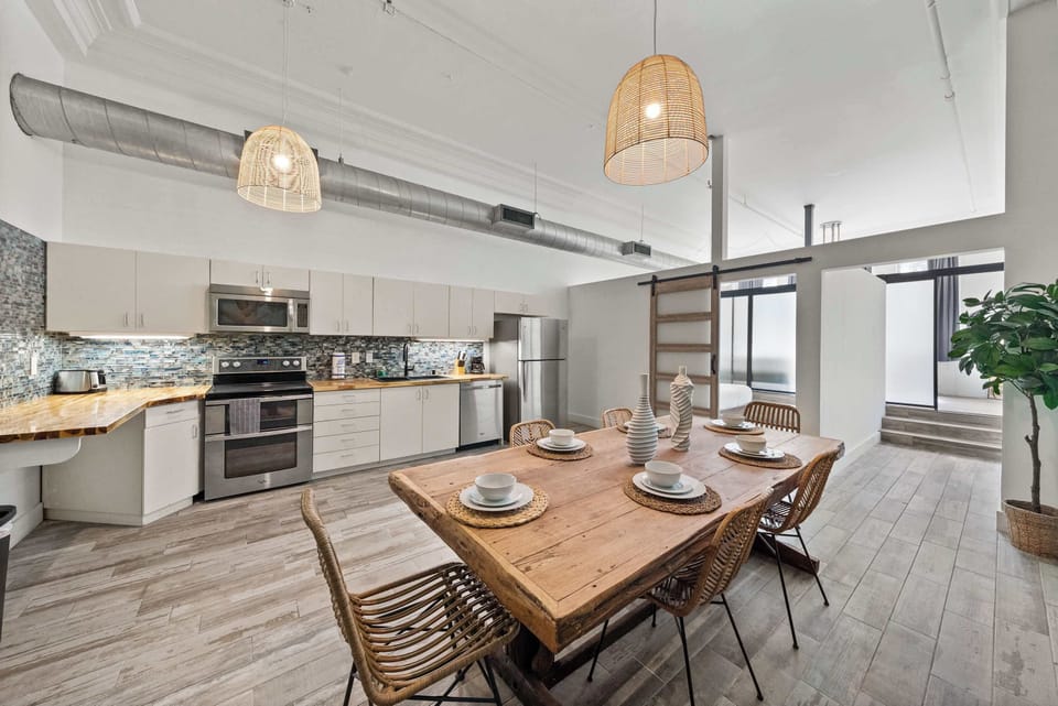 Spacious dining area with large table and open kitchen layout