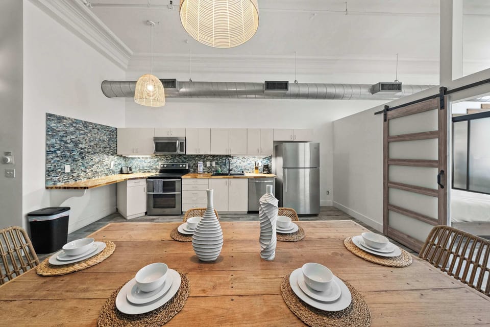 Dining table set for gatherings in an airy open-plan space