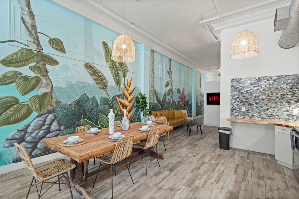 Open-concept living and dining space with artistic wall accents