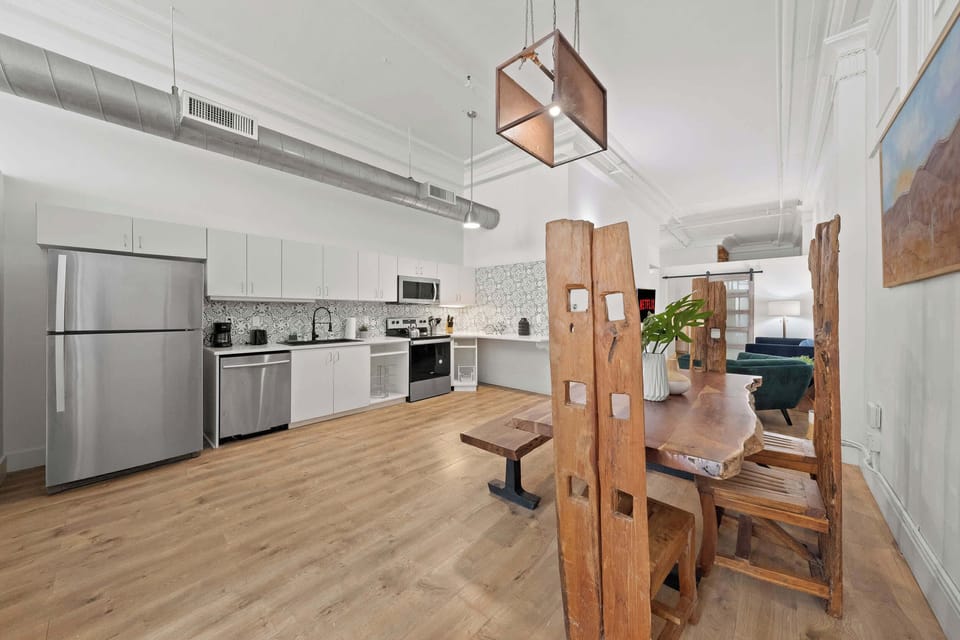Open dining area with high ceilings and stylish wood accents