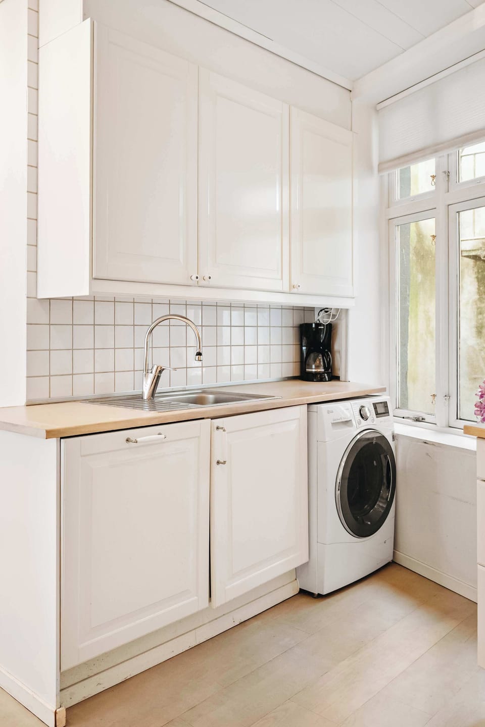 Fully equipped kitchen with washer and sleek cabinetry