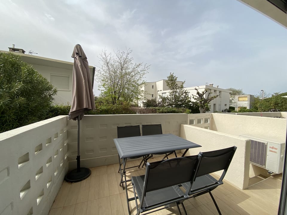 The terrace is furnished with garden furniture, as well as a parasol