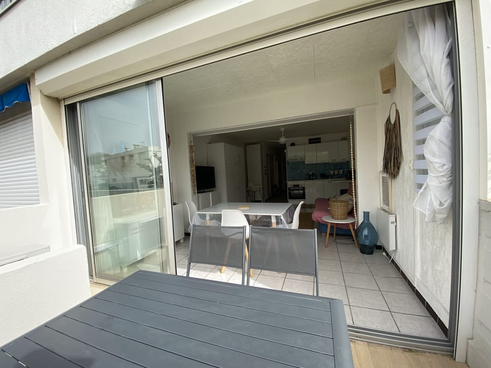 The terrace is furnished with garden furniture, as well as a parasol