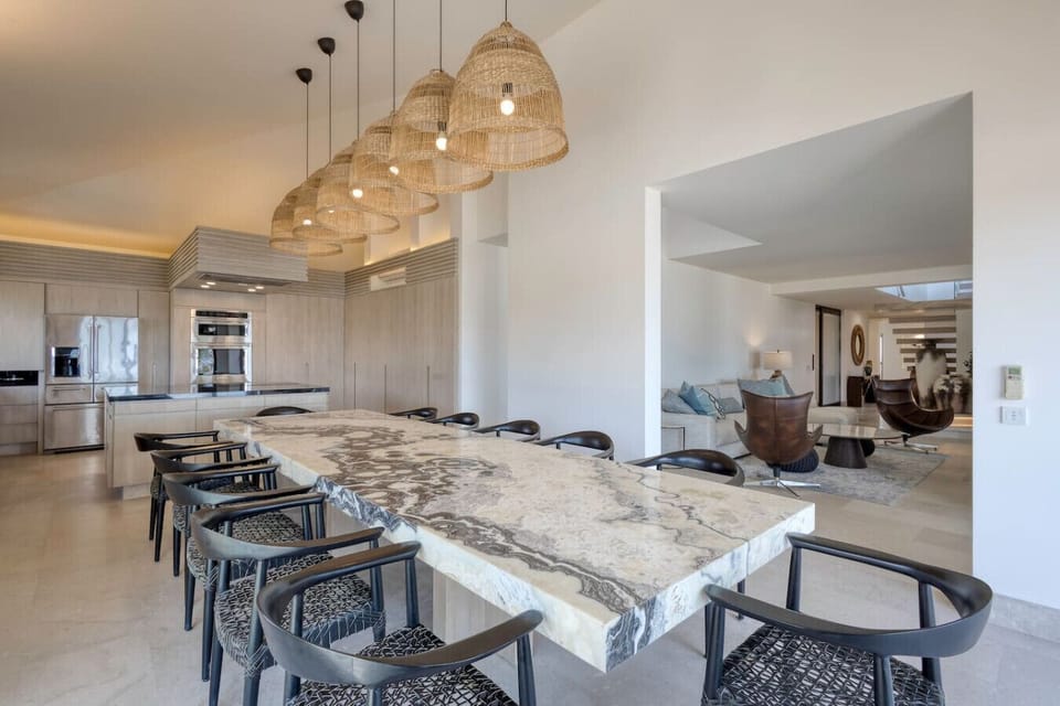 Large dining table with woven pendant lights.
