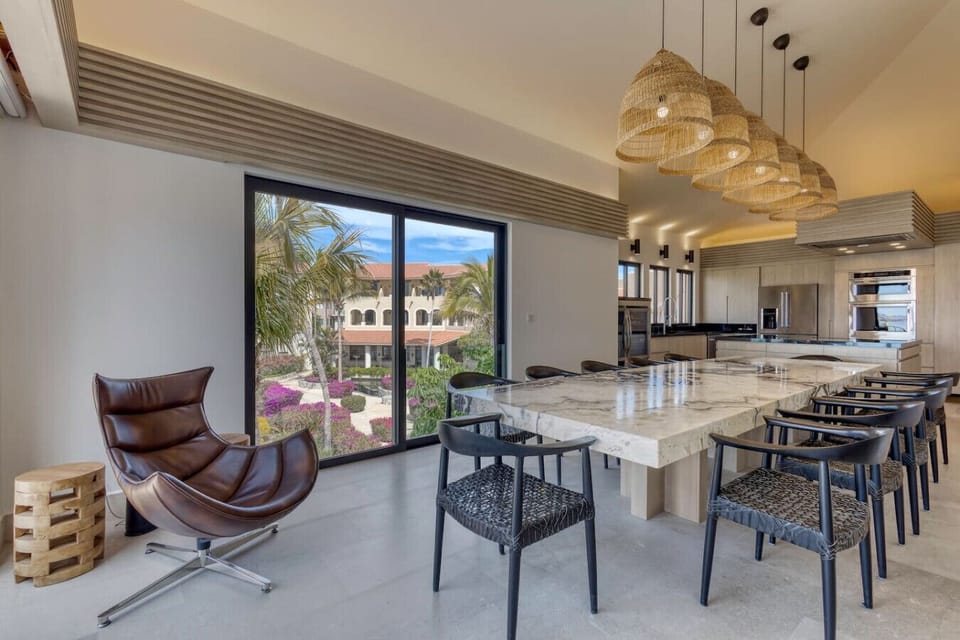 Dining room with large windows and stylish seating.