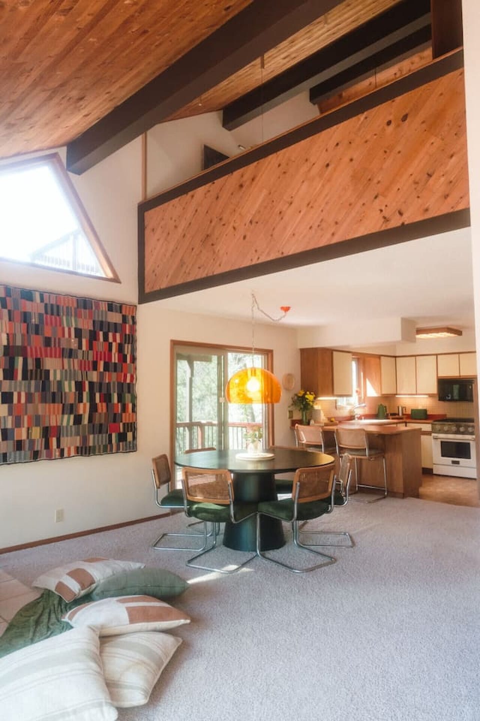 An open, airy space with warm wood accents and natural light, thoughtfully designed for gathering, sharing meals, and creating meaningful moments together.
