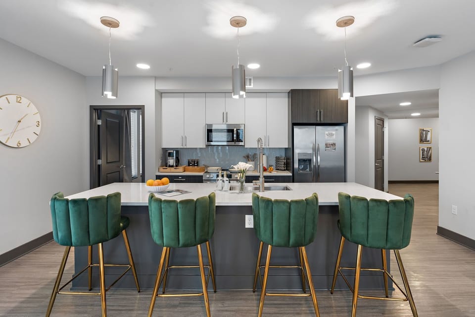 Gather around the oversized island — the heart of this modern kitchen, complete with plush velvet seating and everything you need for a perfect stay.