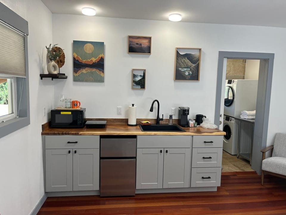 A fully equipped kitchenette with modern essentials – perfect for coffee, snacks, or a cozy meal in.