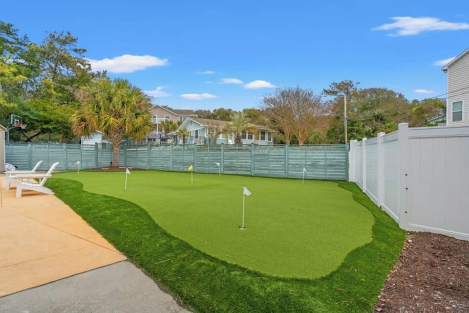 Practice golfing on the putting green.