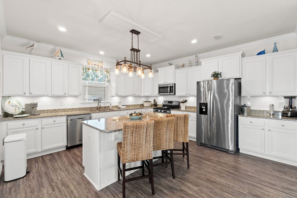 Your spacious kitchen features granite counters, stainless appliances, and a center island where you'll create memorable vacation meals together.