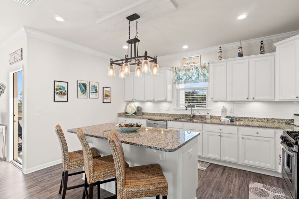 Your bright coastal kitchen features granite countertops, modern appliances, and a breakfast island where you can start each day.