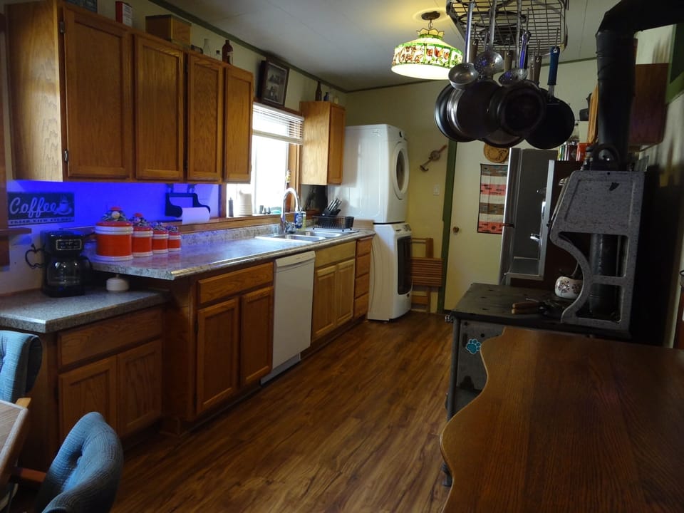 Kitchen with coffee bar, DW, W/D, hanging pans & lots of lit counter space.