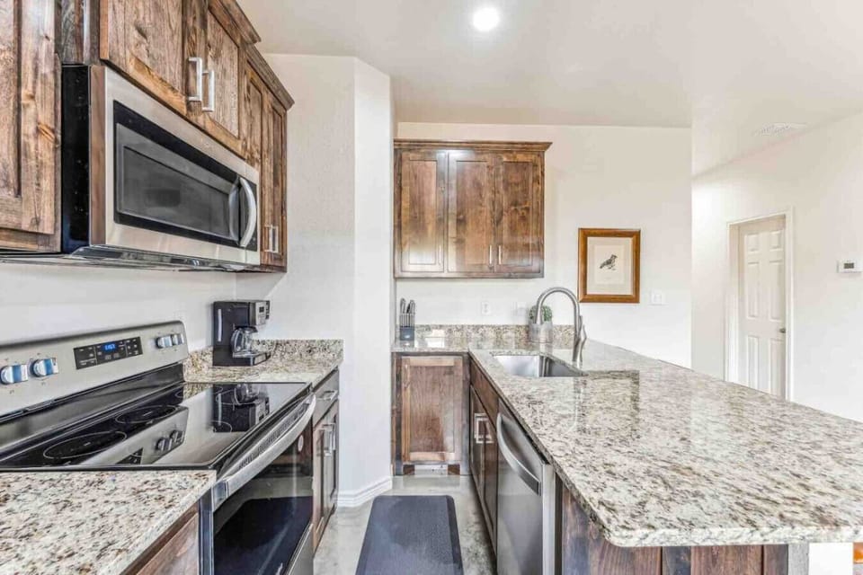 Fully stocked kitchen with range/oven, dishwasher, microwave, refrigerator, all dishes, utensils, pots, pans, toaster, blender, keurig, and more!