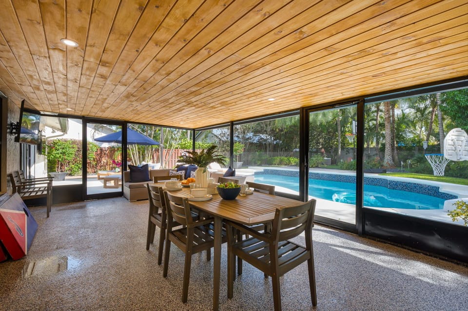 Enjoy the glow of ambient lighting in this spacious screened patio—perfect for quiet mornings or relaxed evening meals.