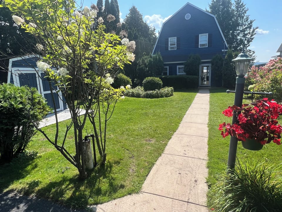 Front Yard, spacious driveway, Crooked Lake located behind the house.