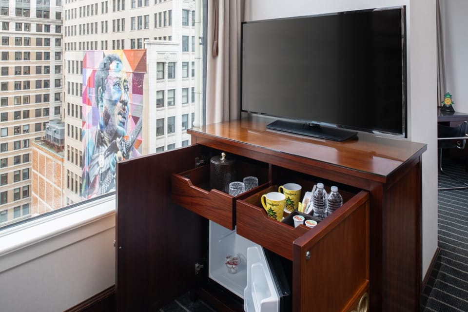 Refresh with in-room minibar essentials beside the big-screen TV.