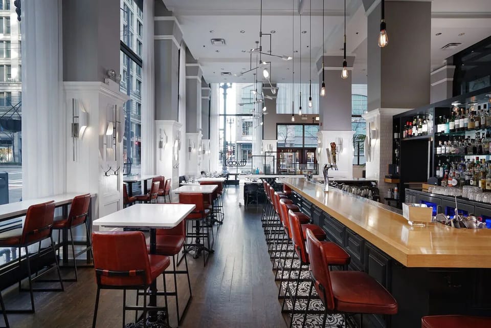 Sip cocktails at the sunlit bar with city views.