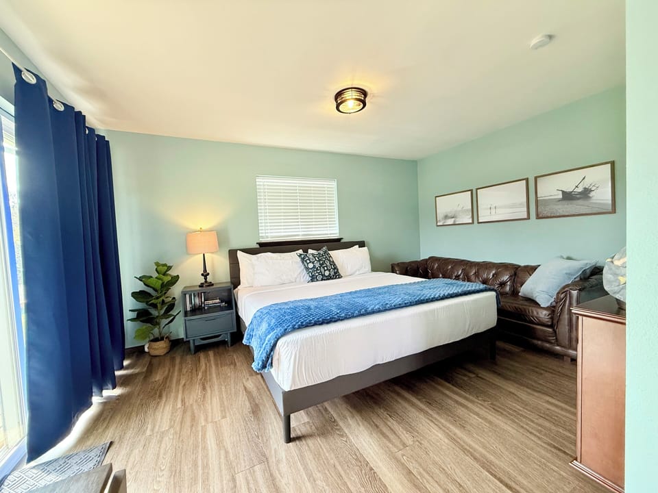 Spacious king suite filled with natural light and relaxed coastal style