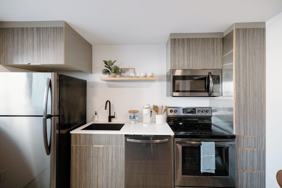 Fully equipped kitchen with modern appliances, Keurig coffee maker, coffee & creamer selection, and all cooking essentials