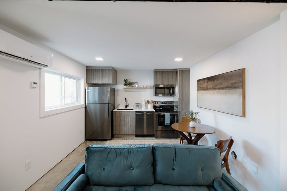 Bright and stylish downstairs living area featuring a Smart TV, cozy seating, and ultra‑fast 500mbs AT&T Fiber Wi‑Fi