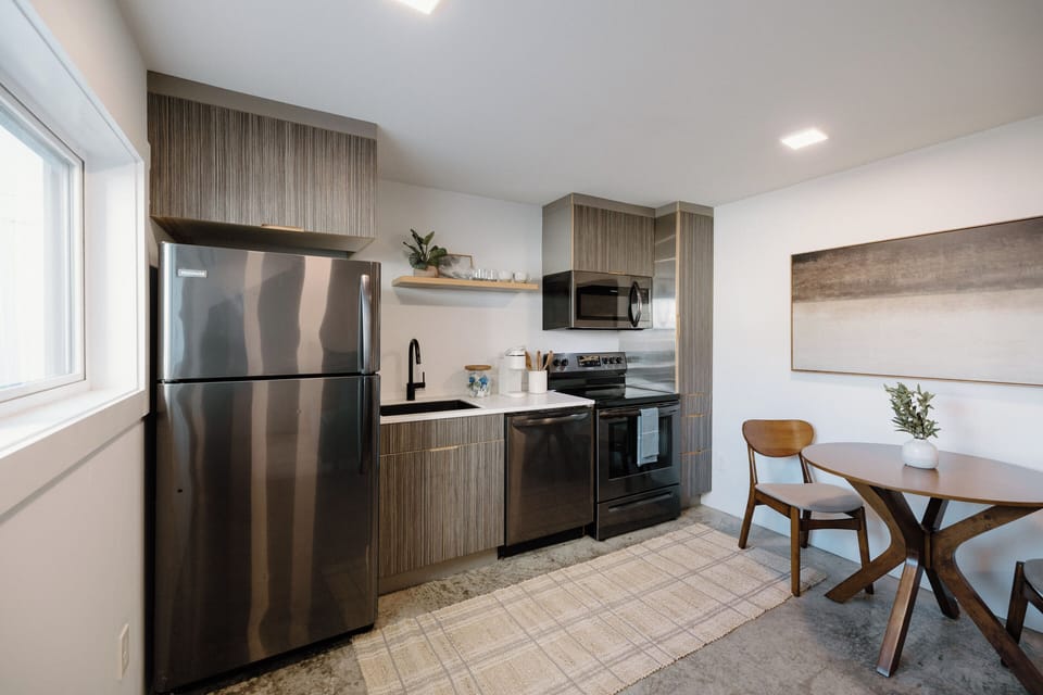 Fully equipped kitchen with modern appliances, Keurig coffee maker, coffee & creamer selection, and all cooking essentials