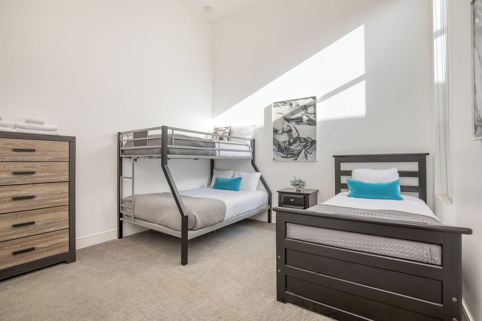 Bedroom 5 features a bunk bed, a twin bed, and an ensuite bathroom. (Polo Villa 4)