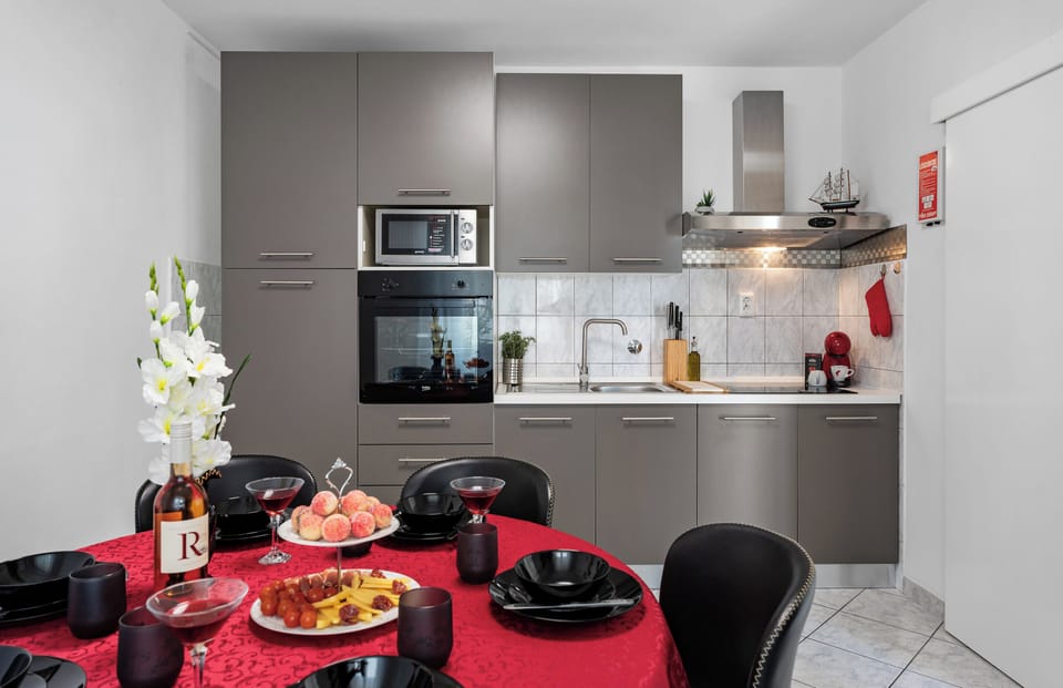 Kitchen is equipped with 2 refrigerators, oven, microwave, coffee maker, kettle