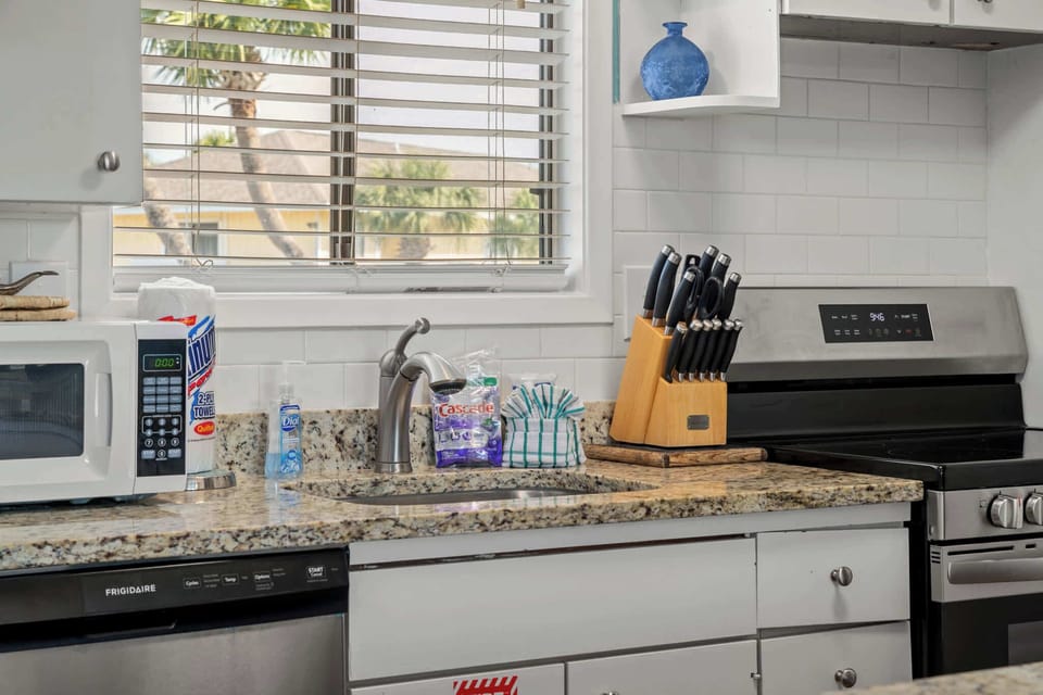 Our kitchen is fully stocked with a fridge, dishwasher, range, microwave, dishes, cutlery, pots & pans, crock pot, blender, toaster, griddle, and more!