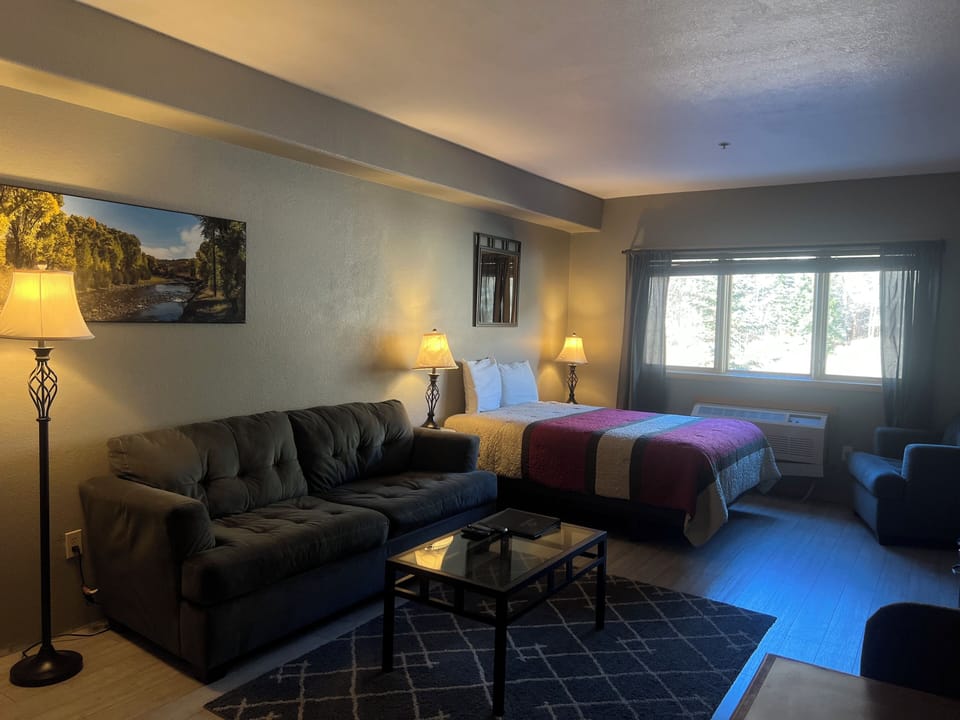 Settle into your cozy retreat where warm lamplight creates the perfect ambiance for relaxation. Your comfortable sofa and queen bed offer flexible spaces to unwind after exploring.