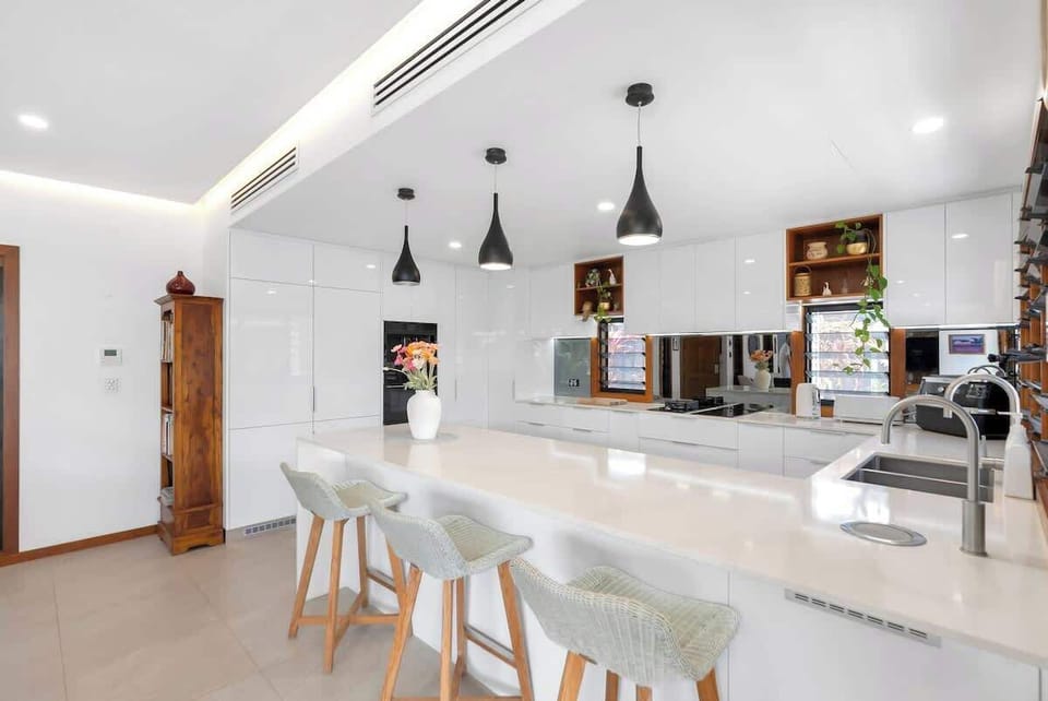 The spacious kitchen bench is the perfect spot for preparing meals while socialising with loved ones.
