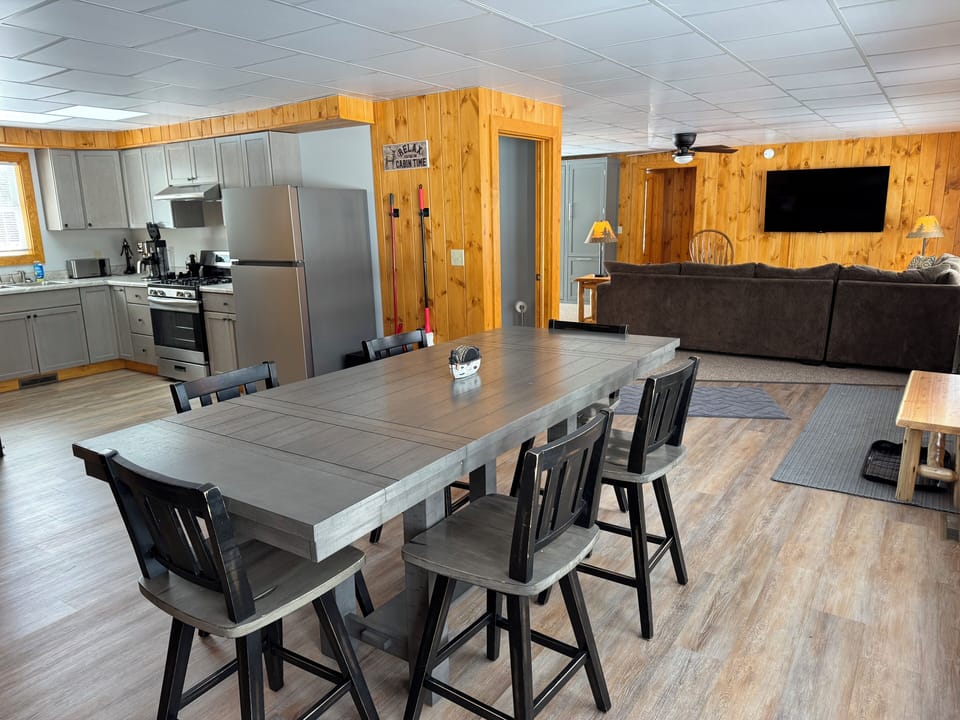 Large Dining room with seating for 6 with views of the kitchen and living room. 