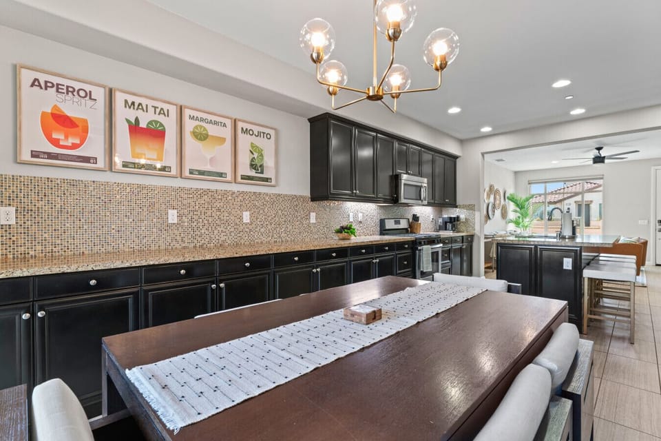 Spacious dining area w/ long table, modern lighting & room for shared meals