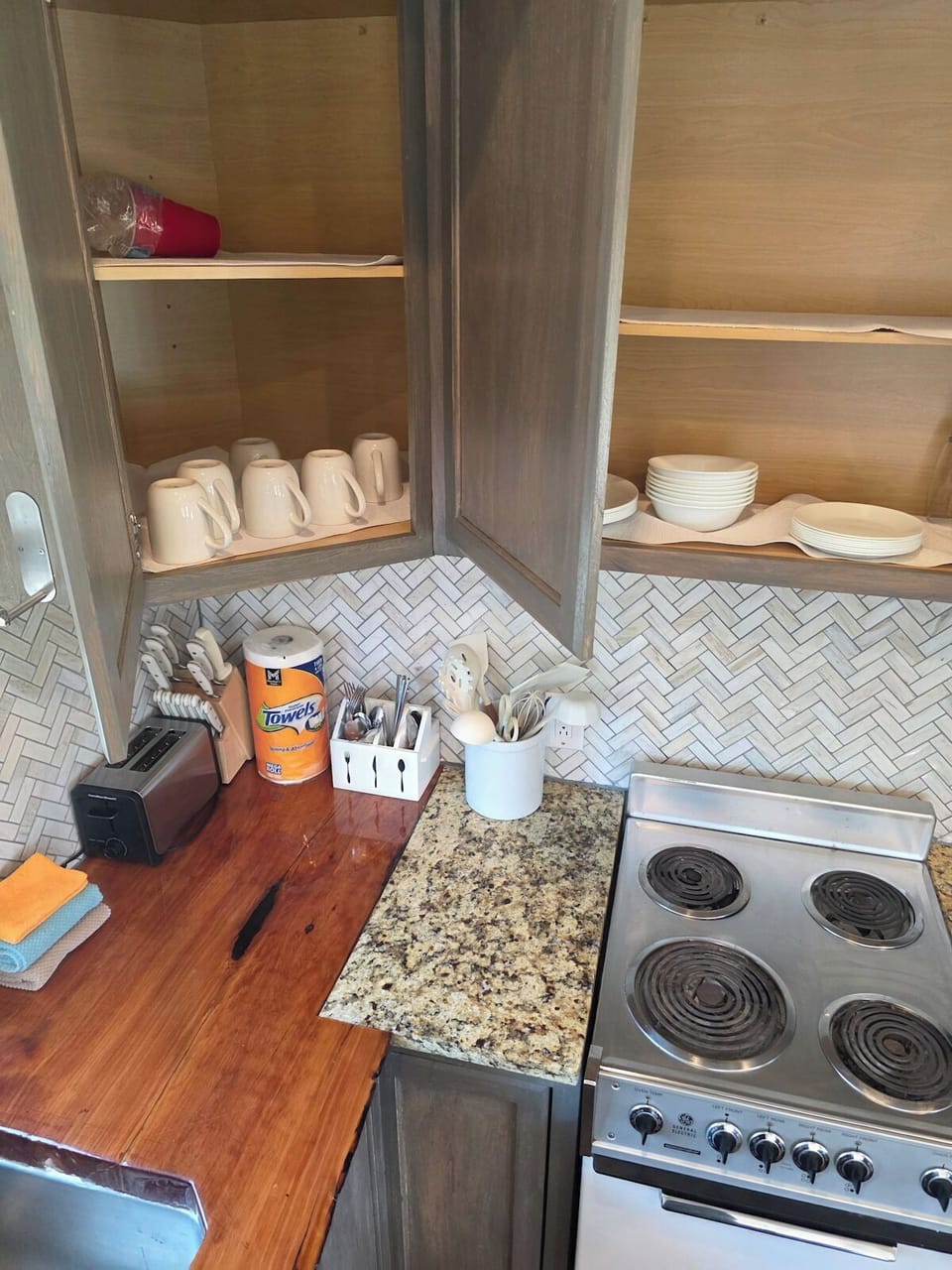 Kitchenette with a live-edge wood counter, farmhouse sink, and microwave.