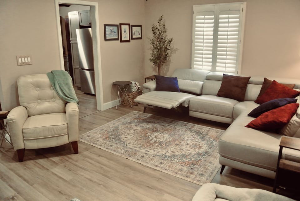 Leather furniture with power reclining sofa and reclining arm chair.