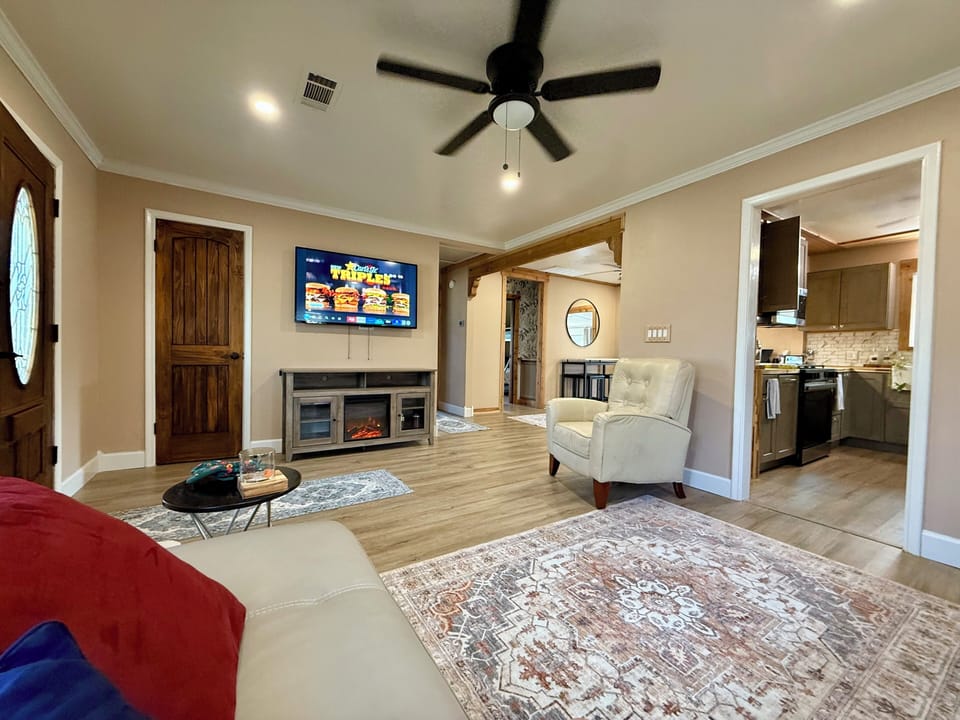 Living Room with fireplace, 55" smart TV, Leather sectional, and reclining chair