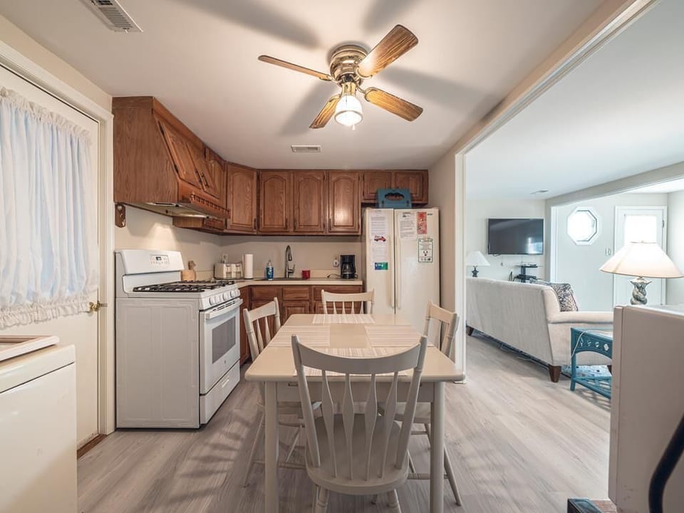 This inviting kitchen connects seamlessly to the dining area, making mealtime effortless and enjoyable.