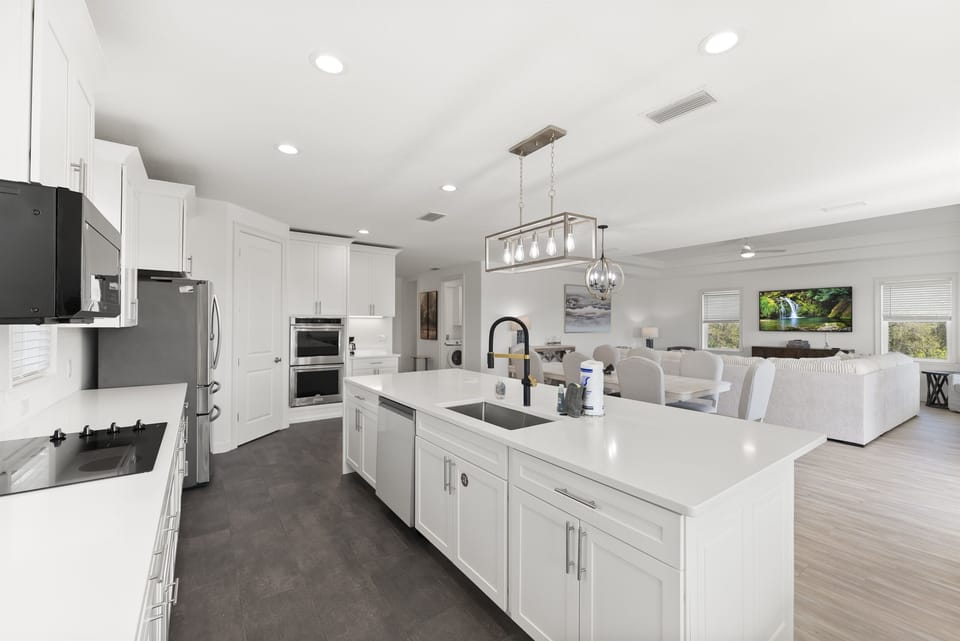 Expansive kitchen layout with stainless appliances and plenty of room to cook