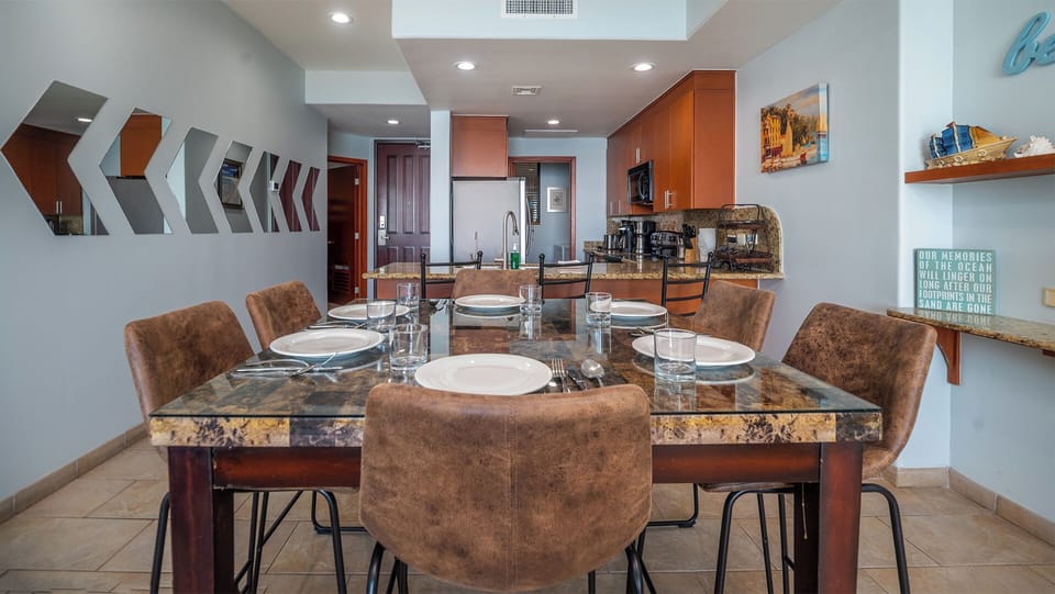 Dining table for six by the kitchen, and mirrored wall accents.
