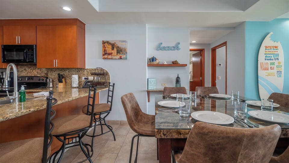 Dining table and additional swivel bar stools at the kitchen counter.