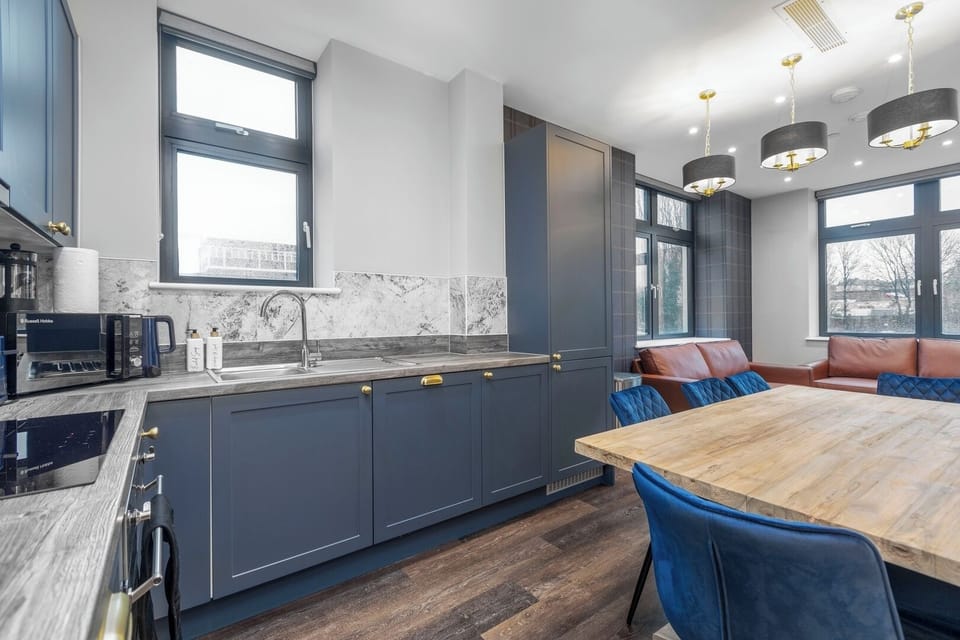 Modern kitchen featuring a stove top, dishwasher, washer/dryer, Nespresso machine, fridge/freezer, oven and microwave.