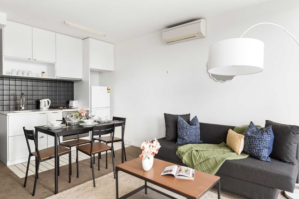 A living area with a 3 seater sofa bed that folds out to a double.